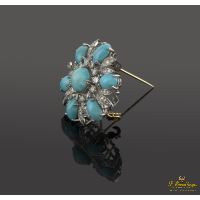 Broche en forma de flor oro blanco turquesas y diamantes.