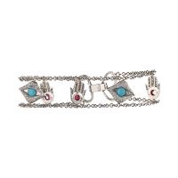 Pulsera en oro blanco con motivos arábigos turquesas y rubíes.