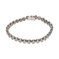 Pulsera riviere en oro blanco con brillantes en chatón.