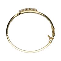 Pulsera rígida en oro amarillo con cinco brillantes.